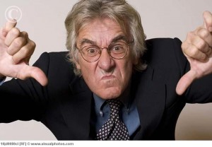 Businessman making thumbs down gesture